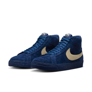 A pair of Nike high-top sneakers in navy blue suede with a beige Swoosh and heel tab, shown on a clean white background.