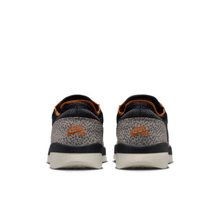 A pair of Nike sneakers shown from the back, featuring a dark navy and gray leopard print upper with orange Nike Swoosh logos and orange lining, set against a plain white background.