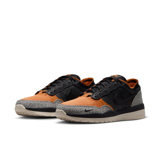 Pair of orange and black sneakers with a white background