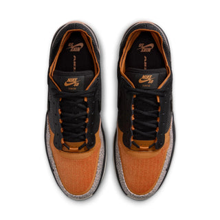 Pair of black and orange Nike sneakers on a white background