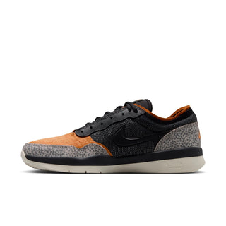 A Nike low-top sneaker in black, orange, and gray leopard print, shown from the side against a plain white background.
