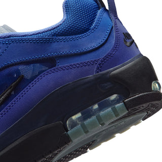 Close-up of a blue sneaker with a visible air bubble on a white background