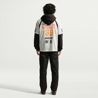 Person wearing a hoodie with visible branding on a white background