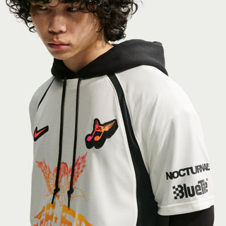 Person wearing a white hoodie with black accents and colorful graphics on a light gray background