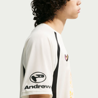 Person wearing a white sports jersey with 'Andrew' branding on a white background