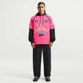 Person wearing a white sports jersey with various logos and text on a Hyper Pink Background