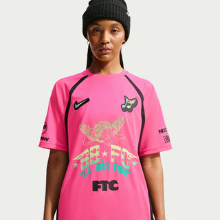 Person wearing a white sports jersey with various logos and text on a Hyper Pink Background