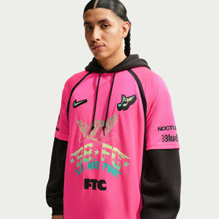 Person wearing a white sports jersey with various logos and text on a Hyper Pink Background