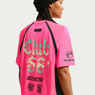 Person wearing a white sports jersey with various logos and text on a Hyper Pink Background
