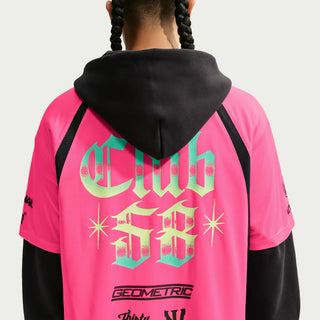 Person wearing a white sports jersey with various logos and text on a Hyper Pink Background