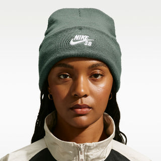 Model wearing the Nike SB Peak Skate Beanie in Camo Green with a folded cuff and white embroidered Nike SB logo