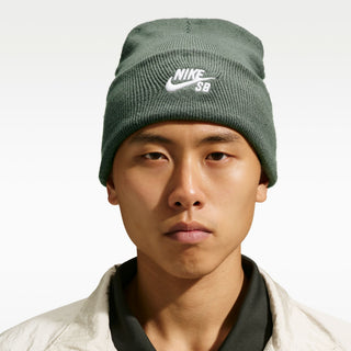 Model wearing the Nike SB Peak Skate Beanie in Camo Green with a folded cuff and white embroidered Nike SB logo
