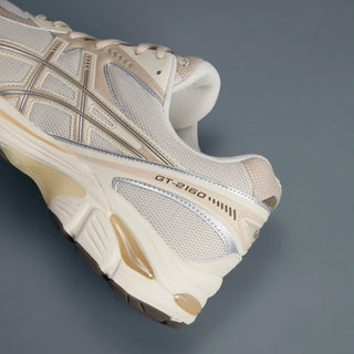 ASICS GT-2160 Shoe in Oatmeal/Simply Taupe with wavy design, GEL® cushioning, and segmented midsole, symbolizing 2010s running shoes.