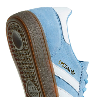 Close-up of a blue Adidas sneaker with 'Spezial' branding on a white background