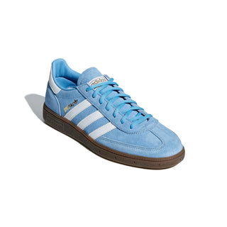 Blue sneaker with white stripes on a light gray background