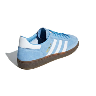 Blue Adidas sneaker with white stripes on a white background