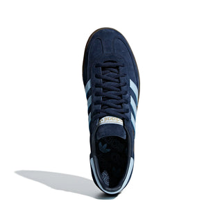 Navy blue sneaker with white stripes on a white background