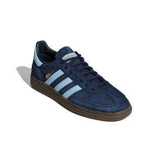 Navy blue sneaker with white stripes on a white background