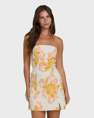 Woman wearing a strapless dress with floral pattern on a white background