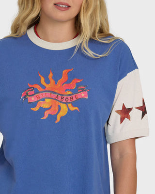 Blue t-shirt with colorful graphic design worn by a person