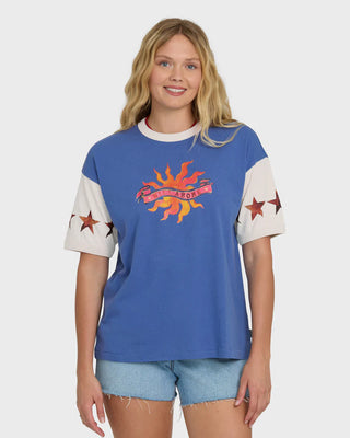 Woman wearing a blue t-shirt with a colorful graphic design on a white background