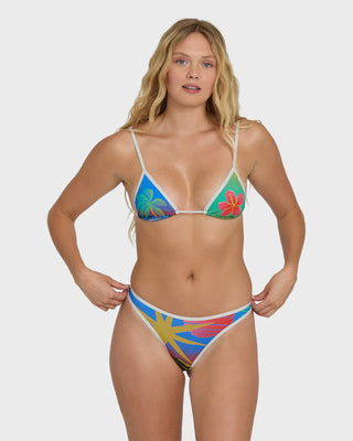Woman wearing a colorful bikini with floral patterns on a white background