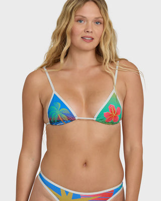Woman wearing a colorful bikini with tropical design on a white background