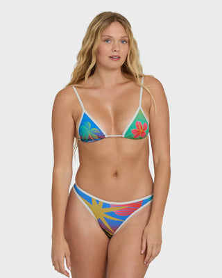 Woman wearing a colorful bikini with floral patterns on a white background