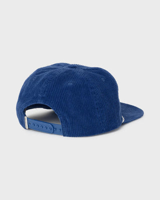 Blue corduroy cap on a light gray background