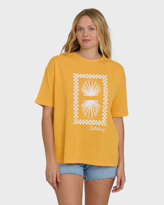 Woman wearing a yellow t-shirt with a shell design on a white background