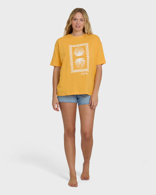 Woman wearing a yellow t-shirt with a graphic design on a white background
