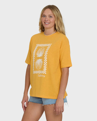 Woman wearing a yellow t-shirt with a graphic design on a white background