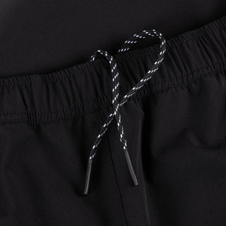 Dime Athletic Snap Pants in Black/Red — polyester/spandex blend with snap side seam plackets, integrated pockets, contrast mesh lining, 3M branding, cinched leg openings, and elasticated speckled drawstring waistband