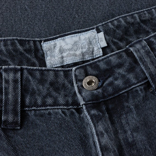 Overdyed blue Dime baggy denim pants with loose fit, classic five-pocket style, and subtle embroidered branding.
