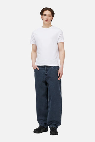 Overdyed blue Dime baggy denim pants with loose fit, classic five-pocket style, and subtle embroidered branding.
