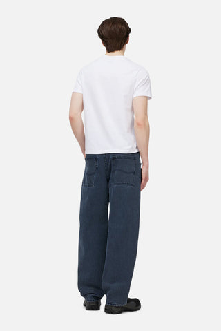 Overdyed blue Dime baggy denim pants with loose fit, classic five-pocket style, and subtle embroidered branding.
