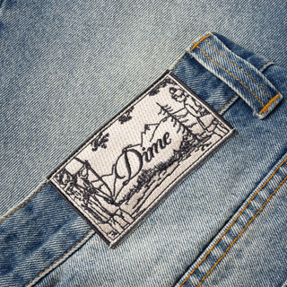 Sandblasted indigo Dime relaxed denim pants with faded wash, straight leg fit, and subtle embroidered branding.
