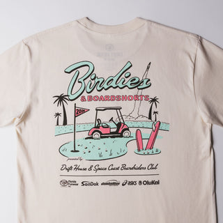Drift House Birdies & Boardshorts Tee in Ecru, featuring a Space Coast golf benefit back graphic with surfboards, palm trees, and a rocket.