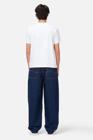 Front view of Dime Baggy Wink Denim Pants in dark Indigo with wide legs, contrast stitching, Western pockets, belt loops, and an embroidered front-pocket logo