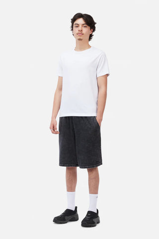 Person wearing a white t-shirt and black shorts on a white background