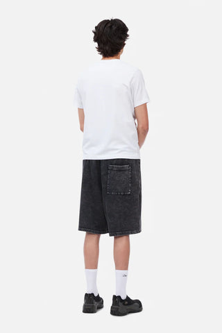 Person wearing a white t-shirt and black denim shorts on a white background