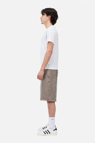 Person wearing a white t-shirt and beige shorts on a white background