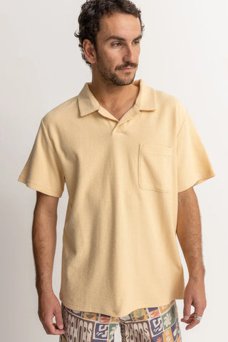 Sand-colored vintage terry polo with chest pocket and soft texture.