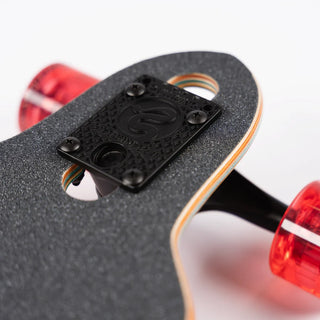 “End view of the Sector 9 9er Mini Fractal showing the layered maple deck, black Gullwing truck, and translucent red wheels.”