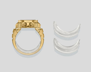 Gold and silver rings on a light gray background
