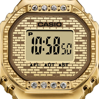 Gold Casio digital watch with brick pattern face and crystal accents