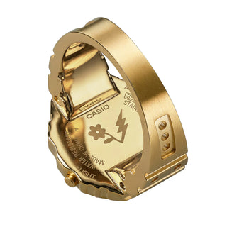 Gold Casio watch back cover with brand logo and design elements on a white background