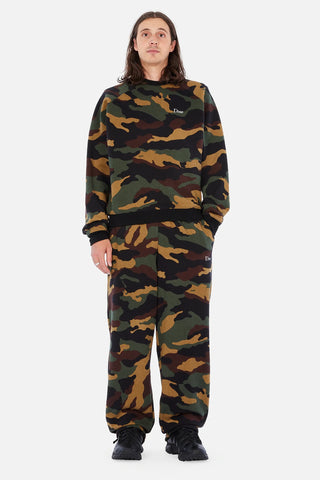 Front view of Dime Classic Logo Crewneck in Dark Camo with green, brown, tan, and black camouflage, a small light-colored embroidered chest logo, and black collar, cuffs, and hem