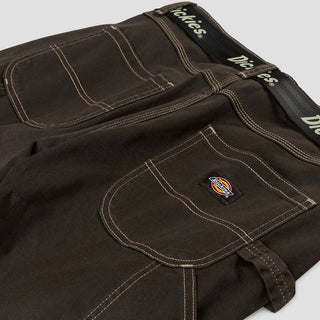 Dickies dark brown high waisted carpenter pants with white stitching and utility pockets.