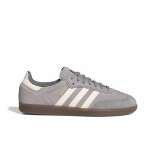 A single Adidas Samba sneaker in gray suede with three cream stripes, a brown gum sole, and gold 'SAMBA' text on the side, shown against a plain white background.